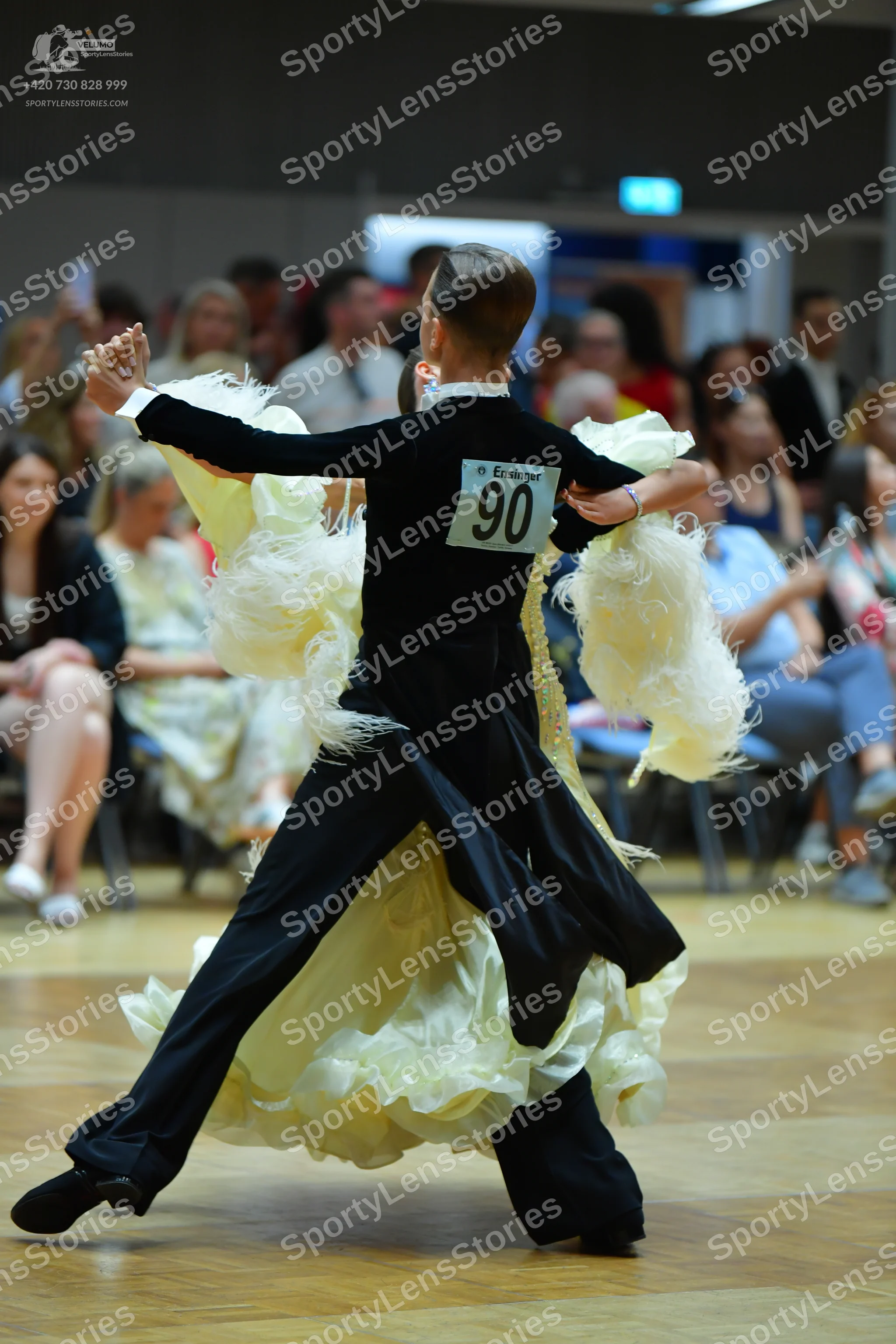 Dancesport competitor #90: Female dancer: black long-sleeved top and a large, voluminous cream-colored ruff