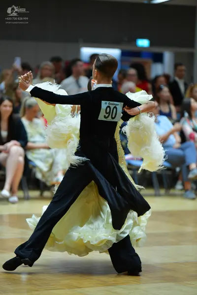 Dancesport competitor #90: Female dancer: black long-sleeved top and a large, voluminous cream-colored ruff