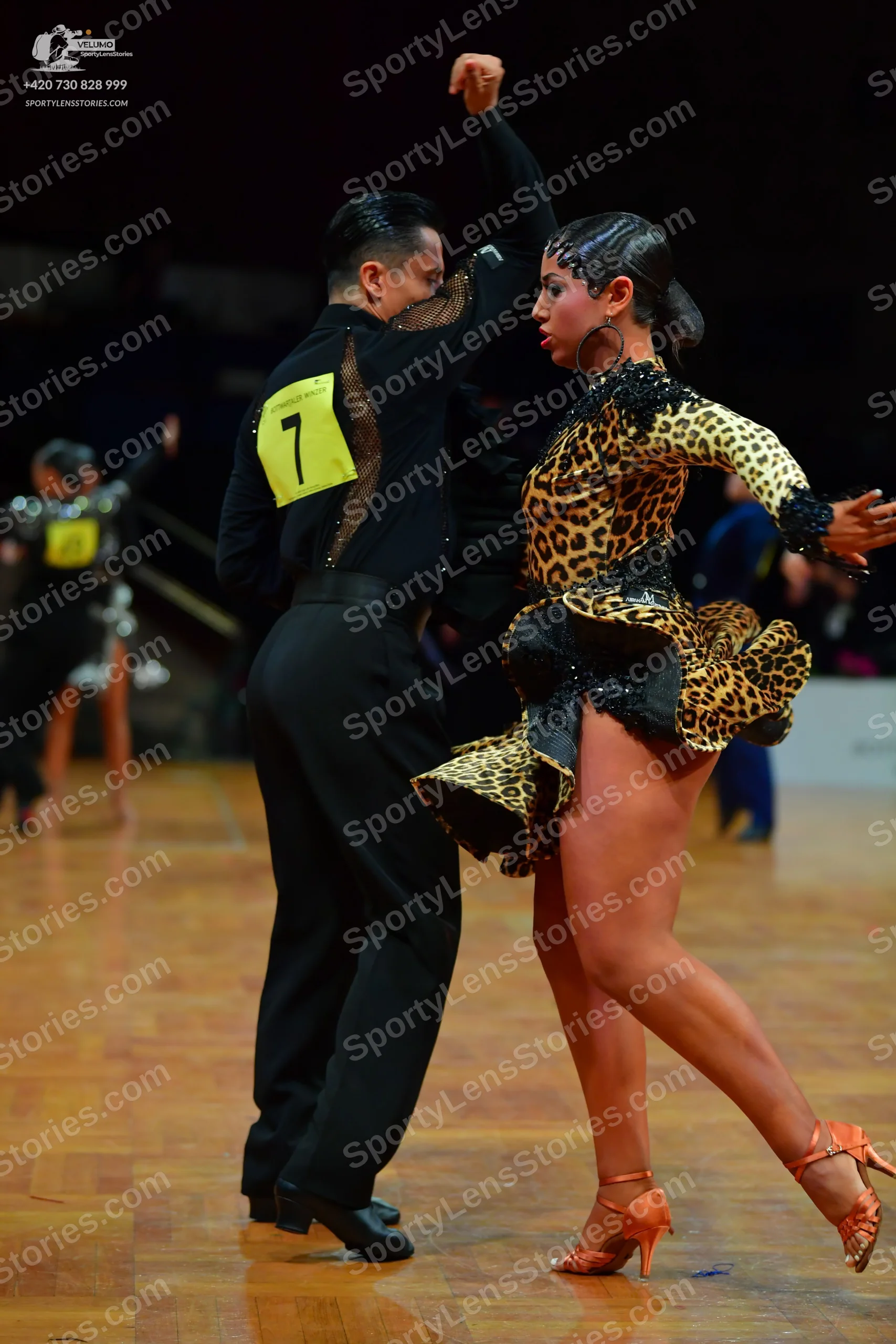Dancesport competitor: Male dancer: black long-sleeved shirt with black sequin embellishments on the ba