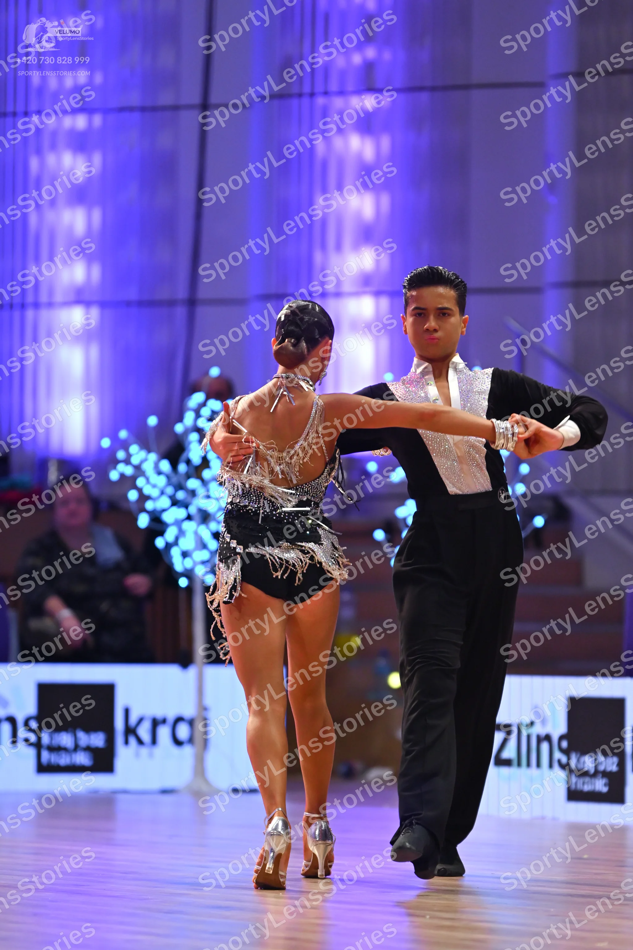 Dancesport competitor: Male dancer: black shirt with a large white/silver sequined front panel and blac