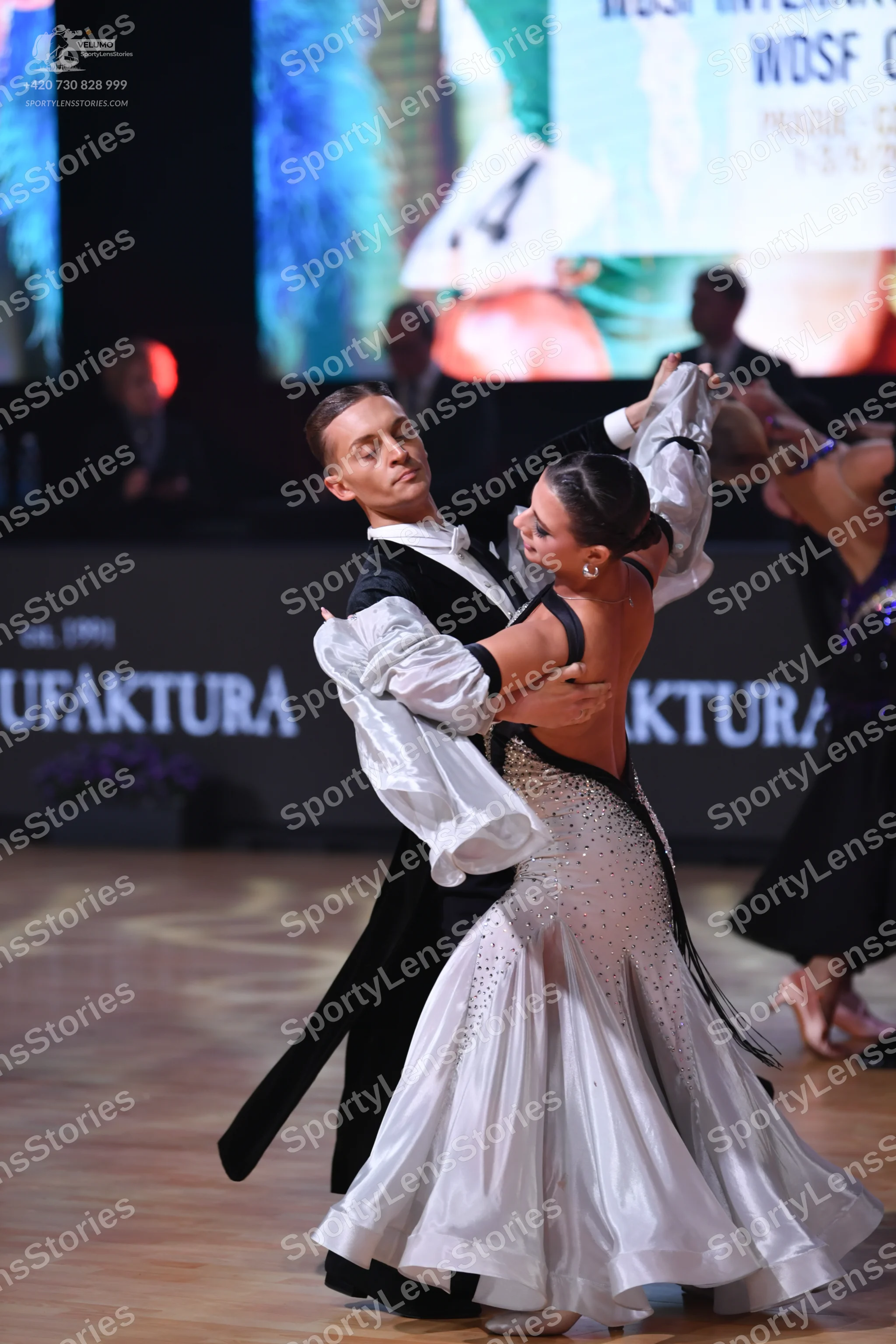 Dancesport competitor: Male dancer: black tailcoat, white shirt with large flowing cuffs, and white bow