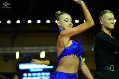 Dancesport competitor: Female dancer: royal blue latin costume with sequins and fringe