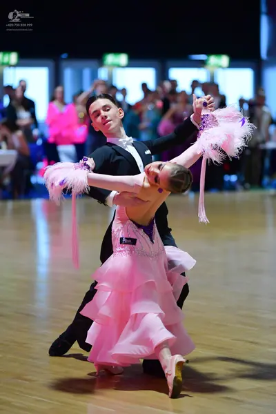 Dancesport competitor: Male dancer: black formal suit with a white shirt
