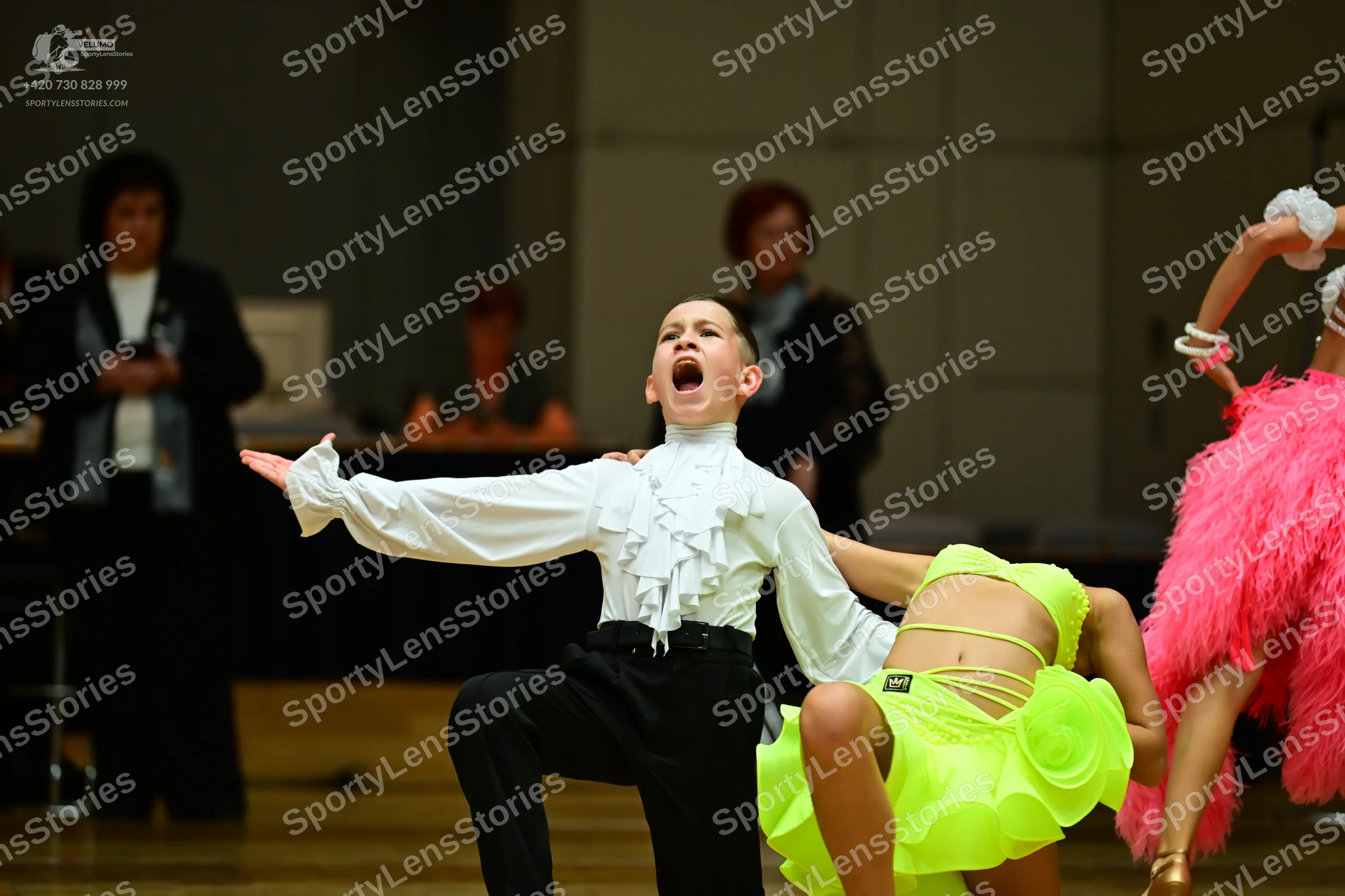 Dancesport competitor: Male dancer: white ruffled long-sleeved shirt and black trousers