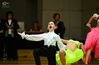 Dancesport competitor: Male dancer: white ruffled long-sleeved shirt and black trousers
