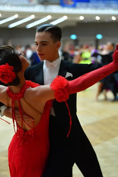 Dancesport competitor: Male dancer: black tuxedo with a white shirt and white bowtie