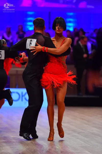 Dancesport competitor: Male dancer: black long-sleeved top with mesh panels and black trousers