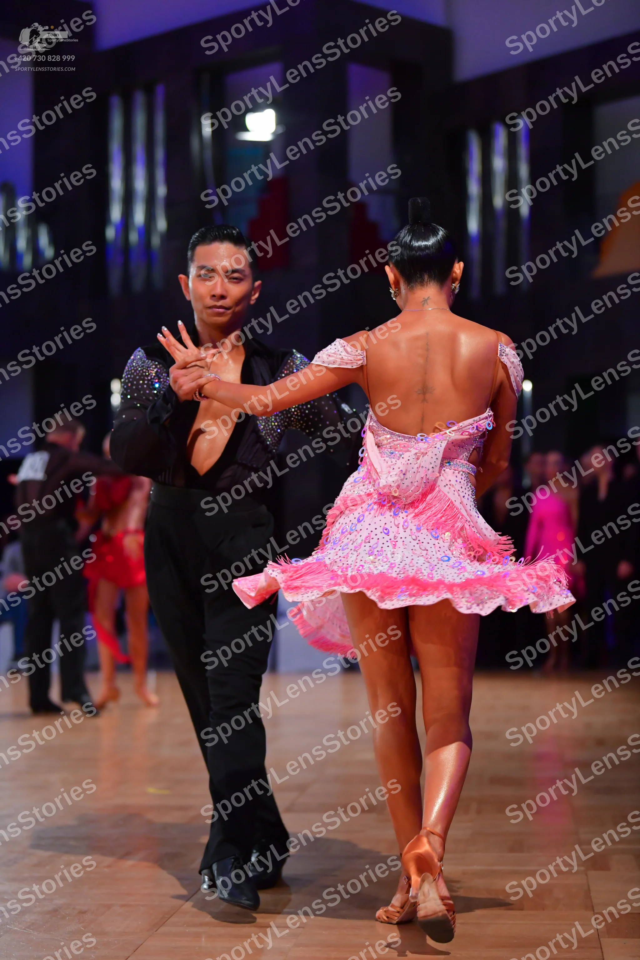 Dancesport competitor: Male dancer: black long-sleeved shirt with a deep V-neck and shimmering details