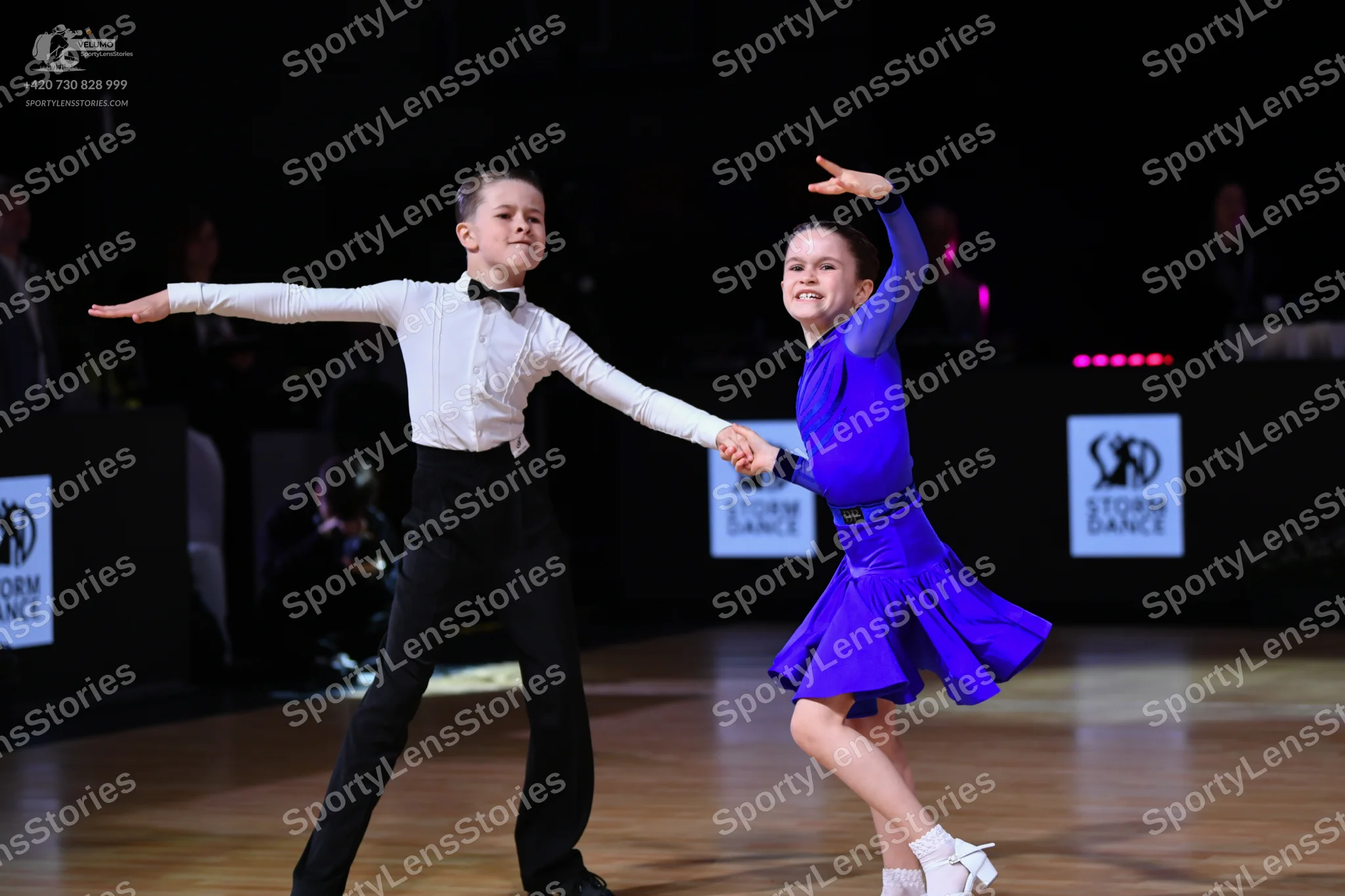 Dancesport competitor: Male dancer: white long-sleeved shirt, black bowtie, and black trousers
