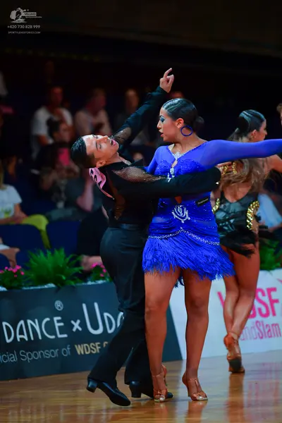 Dancesport competitor: Male dancer: black long-sleeved dance top with mesh sleeve detailing and black t