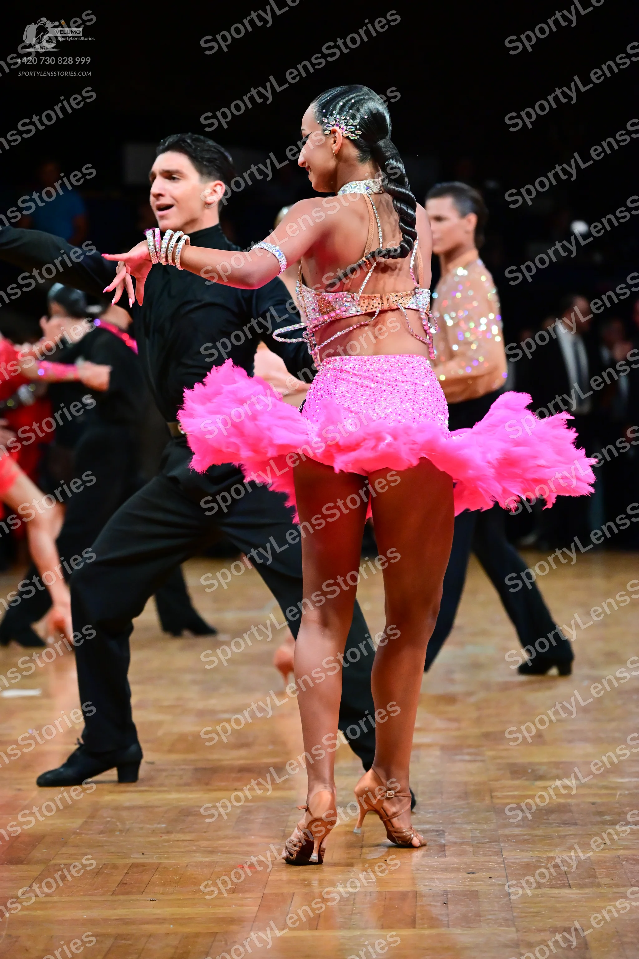 Dancesport competitor: Female dancer: pink latin dance costume with a sequined bodice and a voluminous
