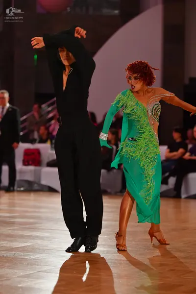 Dancesport competitor: Male dancer: black long-sleeved top and black trousers