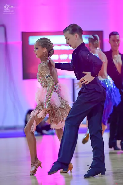 Dancesport competitor: Female dancer: light pink/champagne latin dress with sequins and long fringe