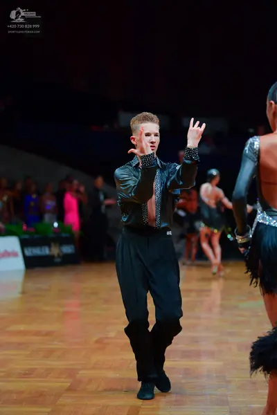 Dancesport competitor: Male dancer: black long-sleeved shirt with a shimmering texture and black trouse