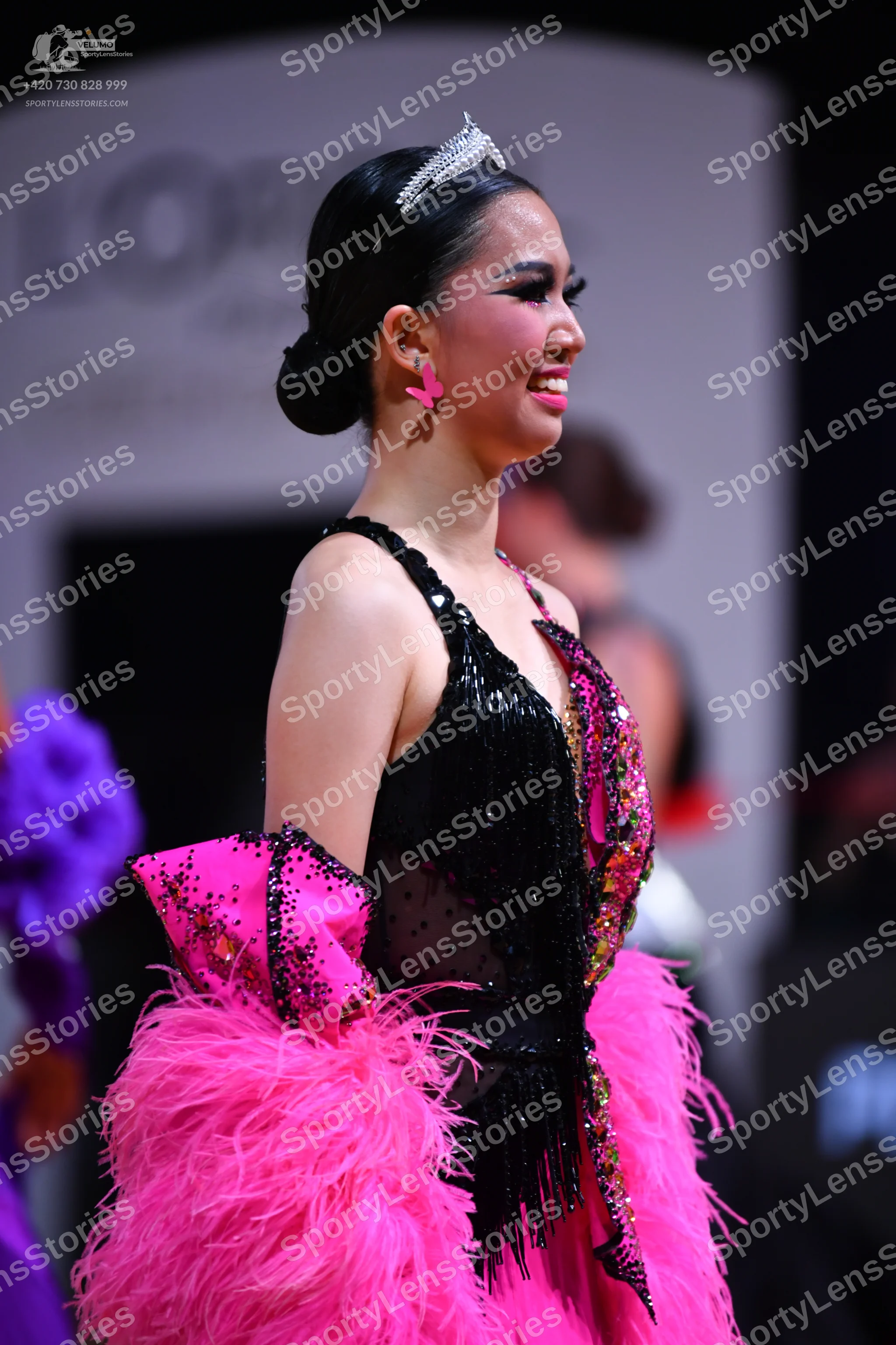 Dancesport competitor: Female dancer: black dance dress with a sequined bodice and black fringe, paired