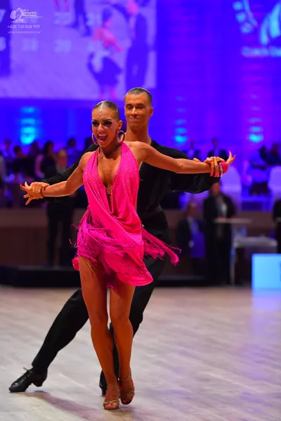 Dancesport competitor: Female dancer: pink latin dress with fringe