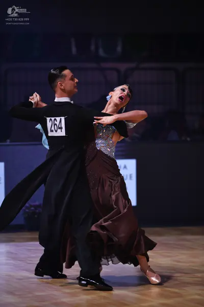 Dancesport competitor: Male dancer: black tailcoat, white wing collar shirt, black trousers, and black 