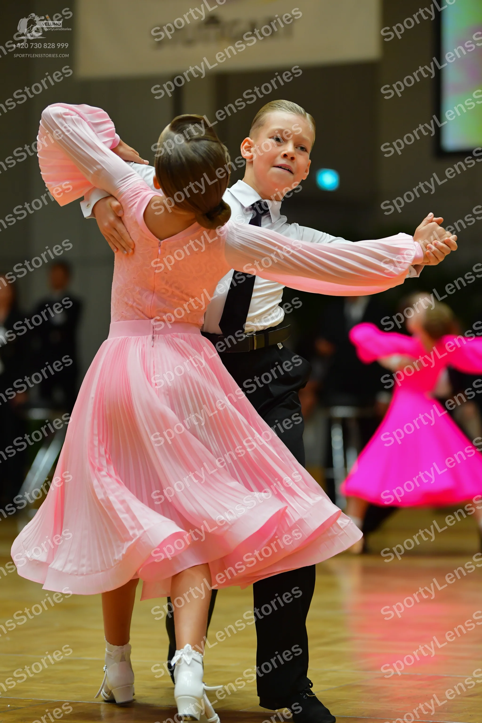 Dancesport competitor: Male dancer: white long-sleeved shirt, black necktie, black trousers, and black