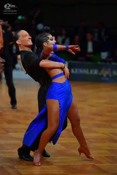Dancesport competitor: Male dancer: black long-sleeved top and black trousers