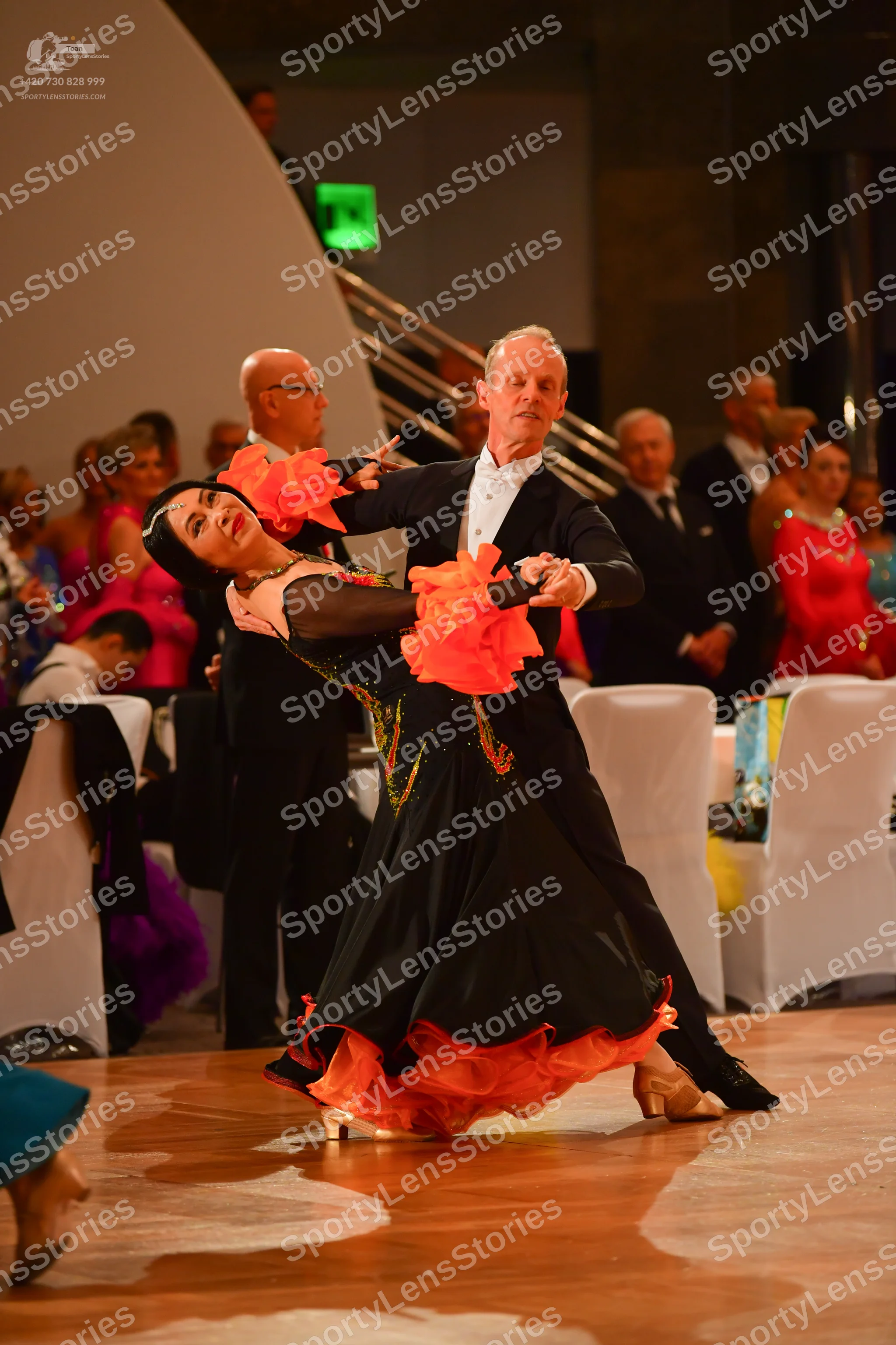 Dancesport competitor: Male dancer: black suit with a white shirt and a white bow tie