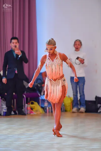 Dancesport competitor #52: Female dancer: nude-colored Latin dress with fringe and sequins, accessorized wi