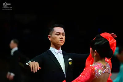 Dancesport competitor: Male dancer: black suit with a white shirt and white bowtie