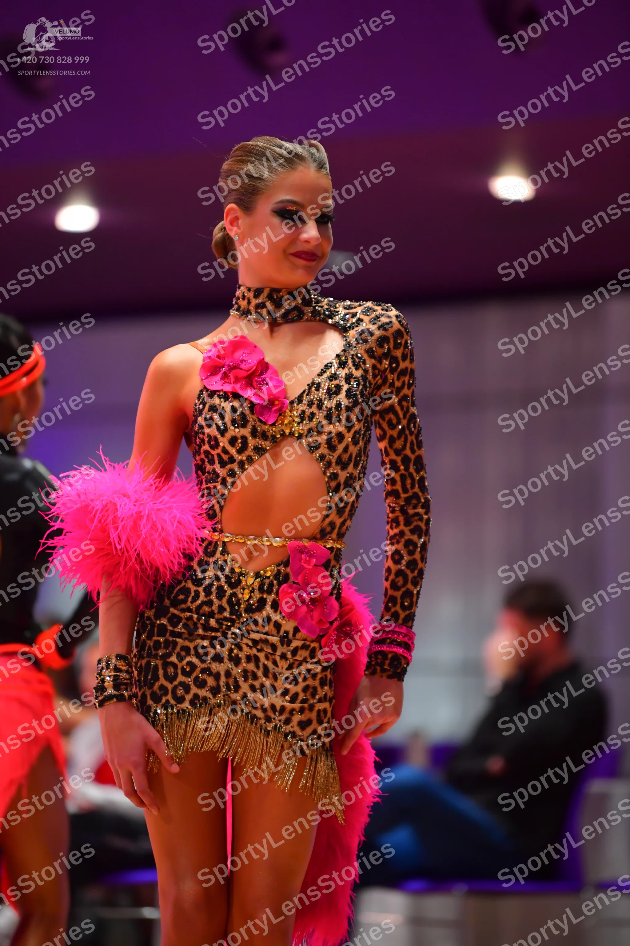 Dancesport competitor: Female dancer: leopard print Latin dress with long sleeves, cutouts, pink floral