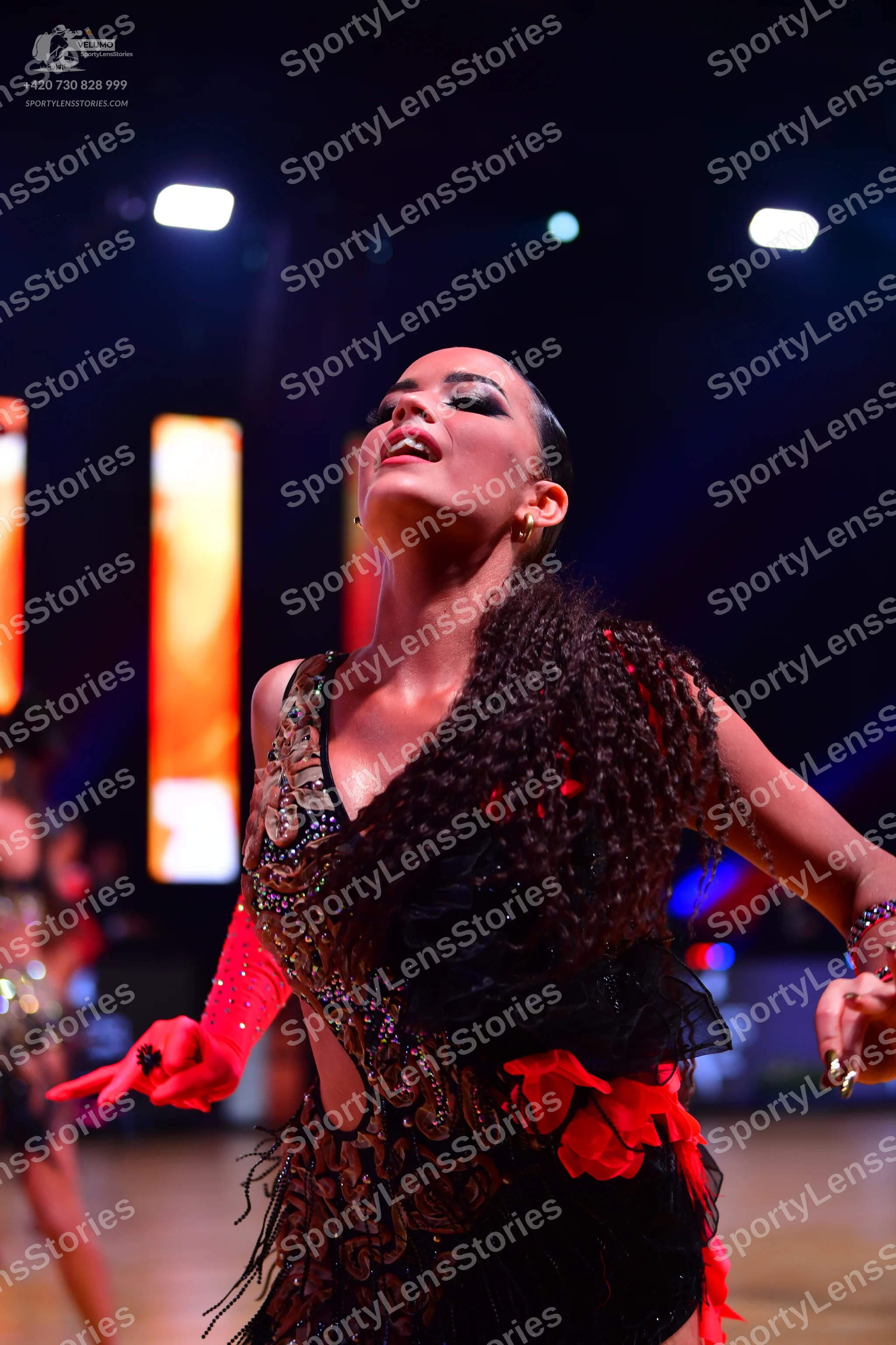 Dancesport competitor: Female dancer: black latin dress with gold and silver sequin and bead embellishm