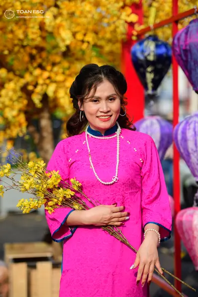 Dancesport competitor: Female dancer: bright pink patterned long-sleeved dress with a high collar and b