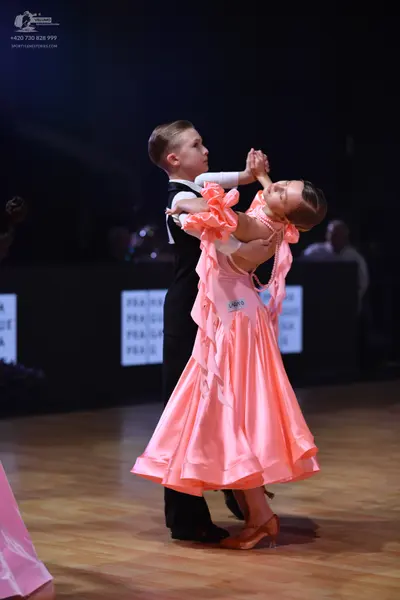 Dancesport competitor: Male dancer: black suit with a white shirt