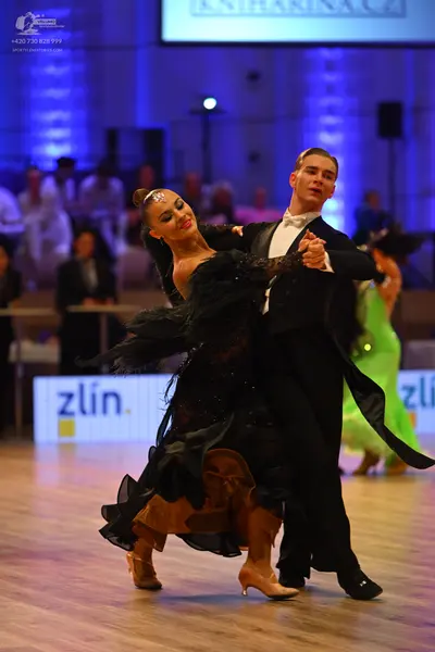 Dancesport competitor: Male dancer: black suit with a white shirt and black trousers