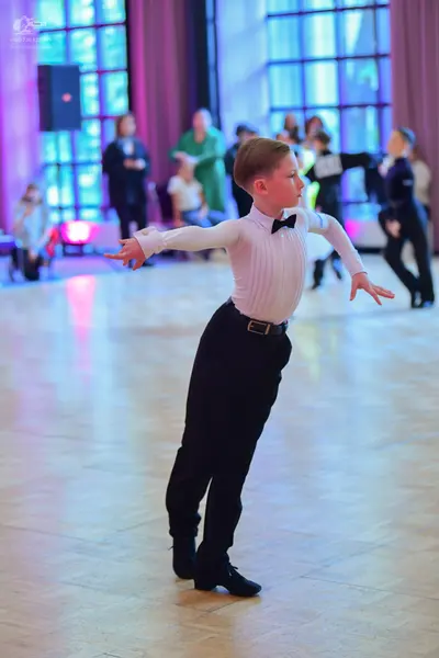 Dancesport competitor: Male dancer: cream-colored long-sleeved shirt with a ribbed texture, black bowti