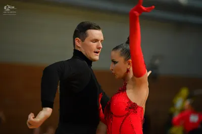 Dancesport competitor: Male dancer: black long-sleeved turtleneck top and black trousers