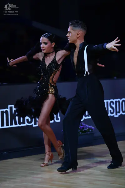 Dancesport competitor: Male dancer: black shirt with white vertical straps and black trousers