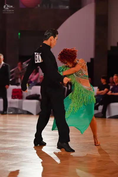Dancesport competitor #67: Male dancer: black long-sleeved shirt and black trousers
