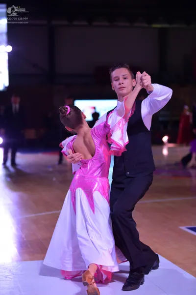 Dancesport competitor: Male dancer: white long-sleeved shirt, black waistcoat, and black trousers