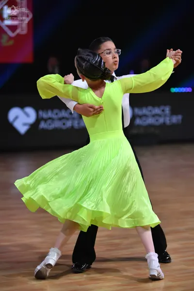 Dancesport competitor: Male dancer: white long-sleeved shirt and black trousers