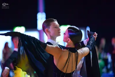 Dancesport competitor: Male dancer: black suit with a white wing-collar shirt and white bow tie