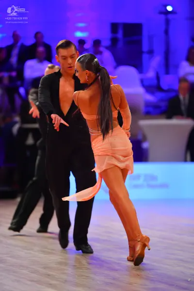 Dancesport competitor: Male dancer: black long-sleeved latin dance top and black trousers