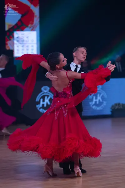 Dancesport competitor: Female dancer: red Latin dress with sequin details and red fringe