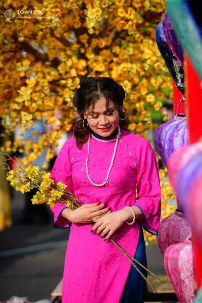 Dancesport competitor: Female dancer: magenta textured long-sleeved dress with a pearl necklace and pea