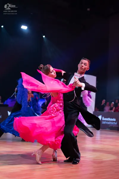 Dancesport competitor: Male dancer: black suit with a white shirt and black trousers