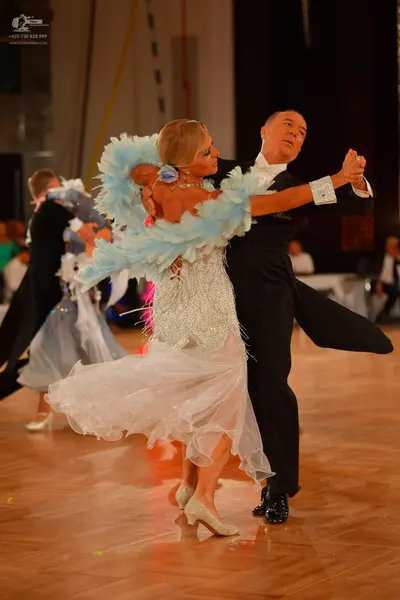 Dancesport competitor: Male dancer: black ballroom suit with a white shirt