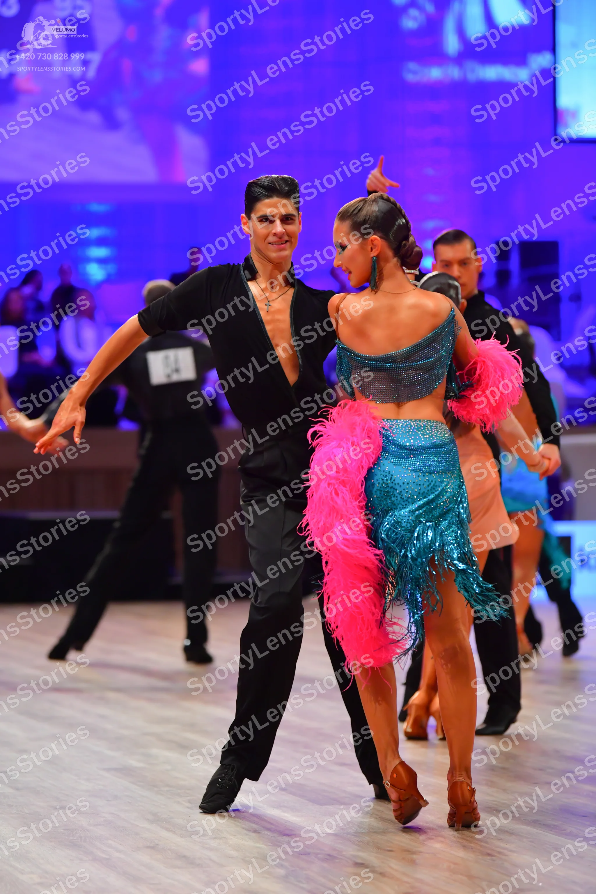 Dancesport competitor: Male dancer: black long-sleeved V-neck top and black trousers