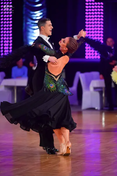 Dancesport competitor: Male dancer: black suit with a white shirt and white bow tie