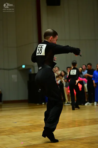 Dancesport competitor #58, #52: Male dancer: black long-sleeve shirt and black trousers