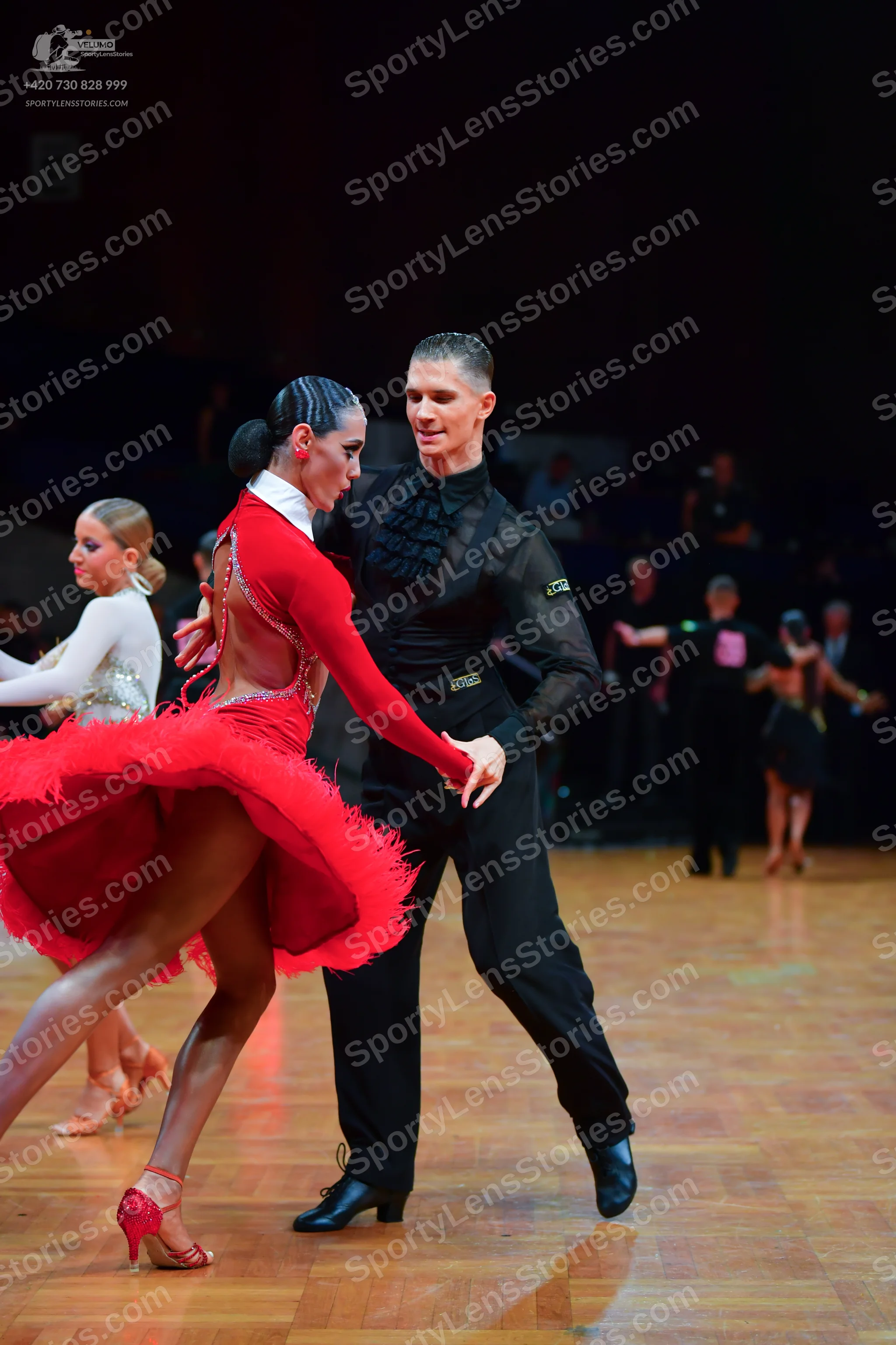 Dancesport competitor: Male dancer: black long-sleeved shirt with textured/sequined chest and black tro