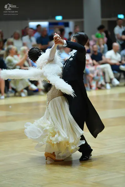 Dancesport competitor: Male dancer: black tailcoat, black trousers, and black dance shoes