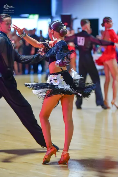 Dancesport competitor #41: Male dancer (foreground): black long-sleeved shirt and black trousers