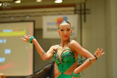 Dancesport competitor: Female dancer: green latin dress with sequins and beads